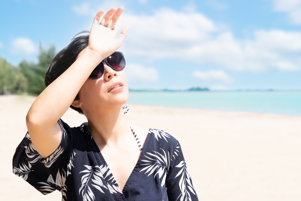 Woman under the strong ultraviolet rays of the sun